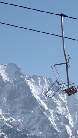 snowy mountain range with ski lift