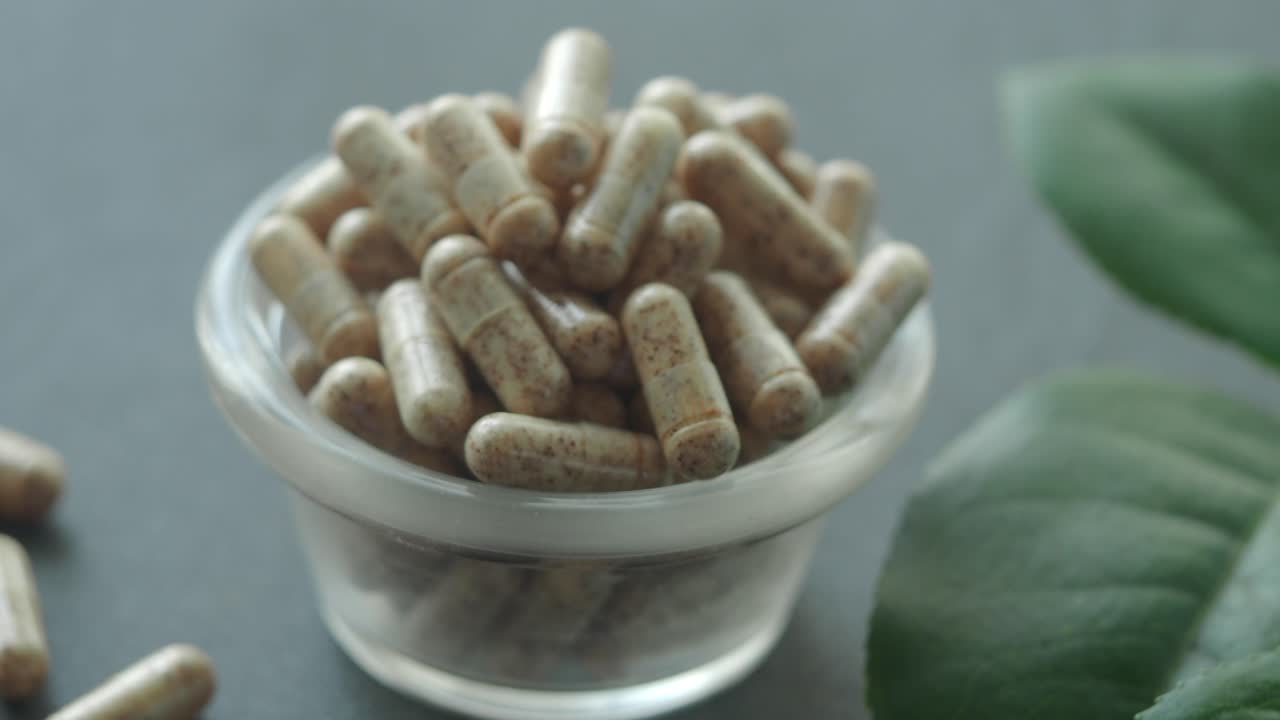 Natural Dietary Supplement Capsules in Glass Bowl