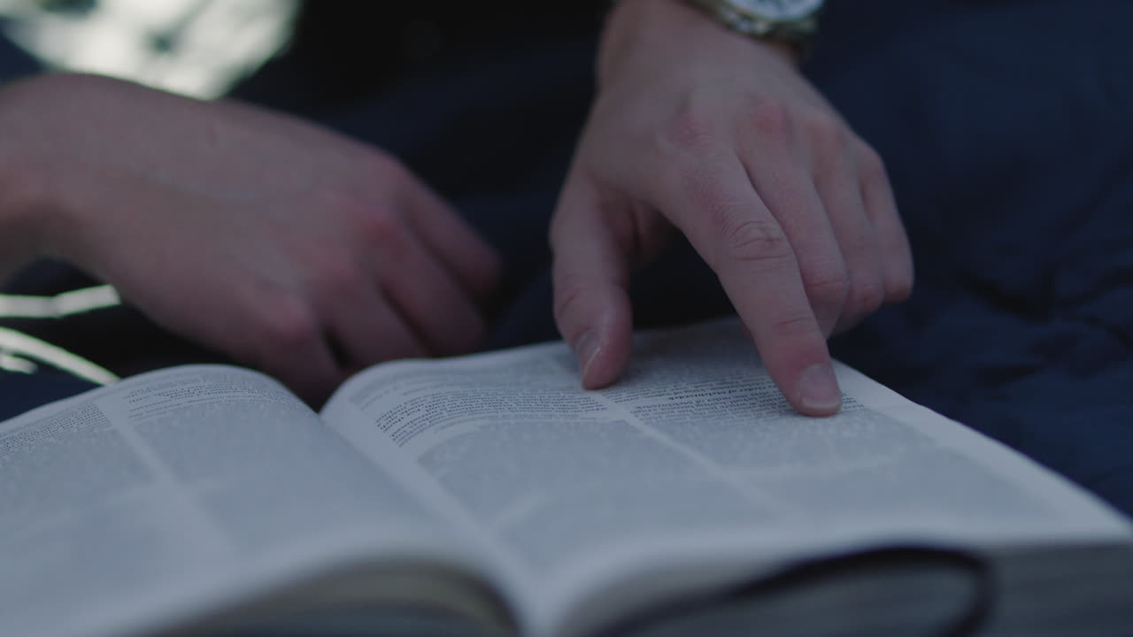 Man reading a book outdoors
