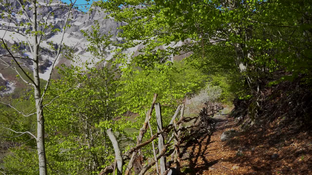 caminando en un callejón de montaña cercado en los alpes albaneses cerca de un pueblo turístico