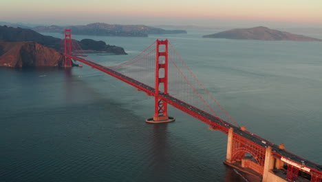 wide establishing shot of golden gate bridge glowing in the sunset