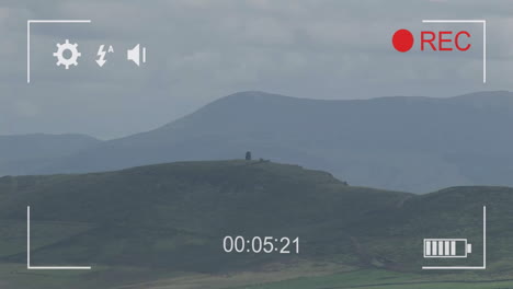 animation of digital video camera interface over rural landscape background