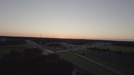 Dolly during sunset in small town near highway