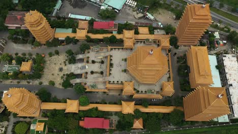 Top-down-drone-shot-flying-in-over-a-large-Buddhist-Temple-or-Pagoda-in-Ho-Chi-Minh-City,-Vietnam