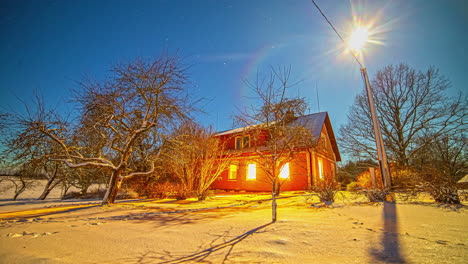 moon and stars so bright that they cast shadows across the snow in the backyard of a countryside home - time lapse