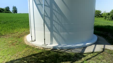 Shadow-of-a-worker-descending-the-outside-staircase-of-a-windmill,-casting-a-silhouette-on-the-exterior