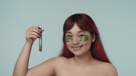 woman with eye patches and test tube