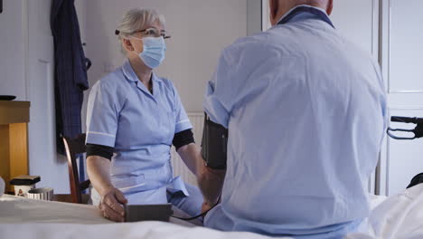 nurse checking patient's blood pressure