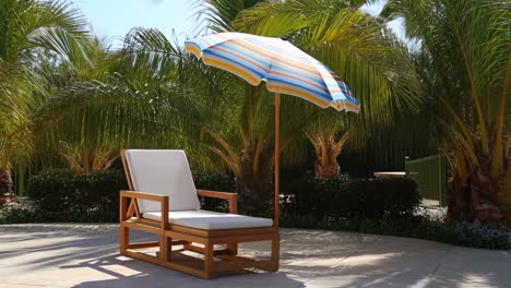 outdoor lounge chair with a colorful umbrella on a sunny patio surrounded by palm trees