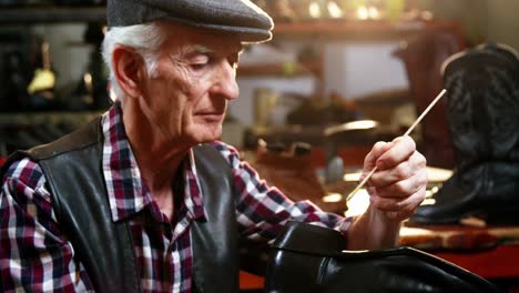 shoemaker repairing a shoe