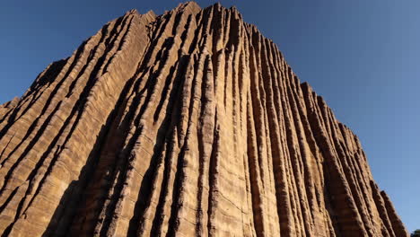 abstract textured rock formation against blue sky