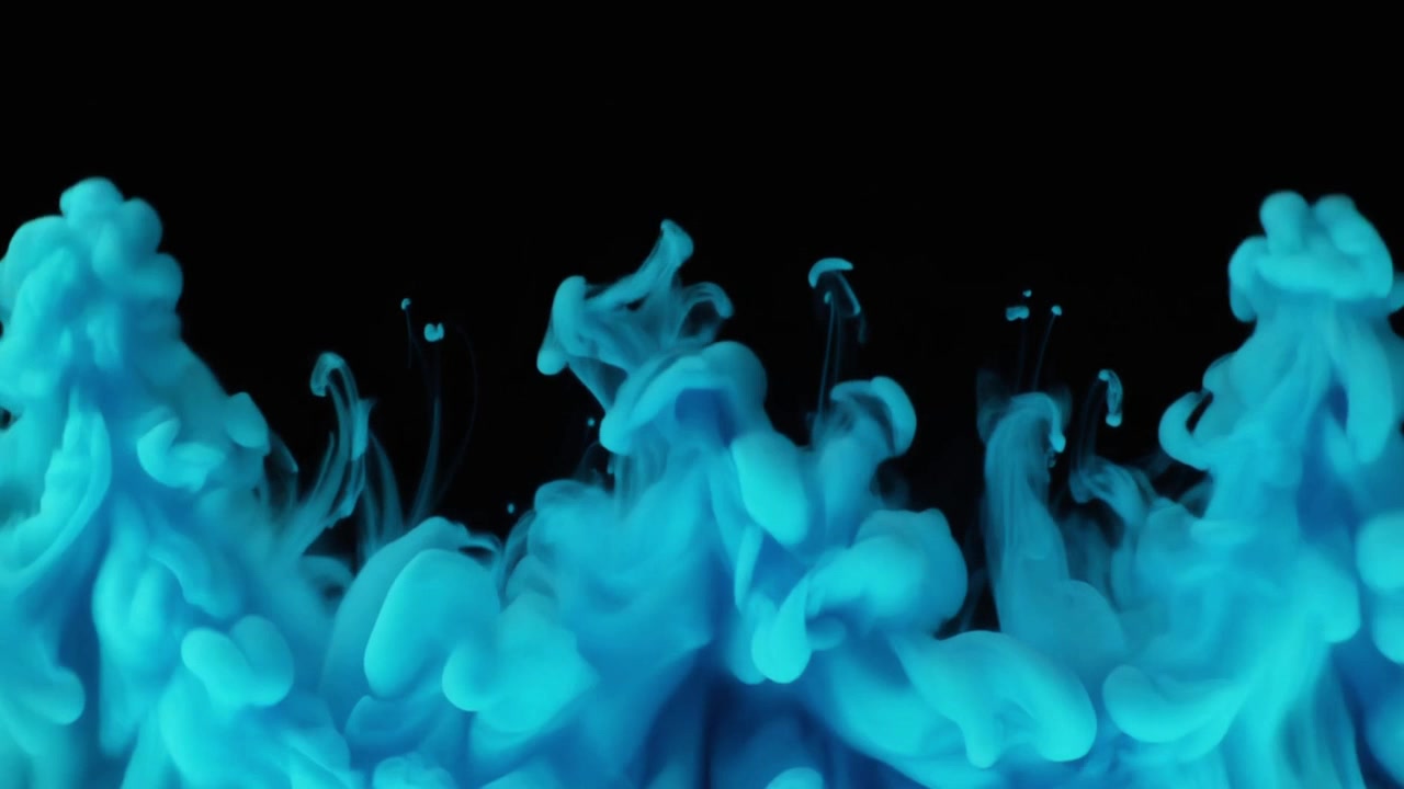 Inchiostro blu che si diffonde nell'acqua su sfondo nero