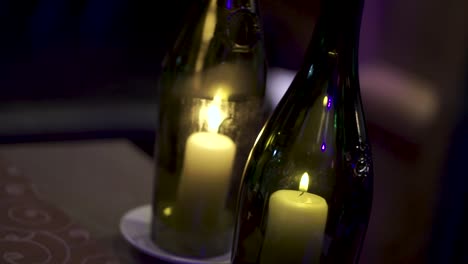 candles in wine bottles