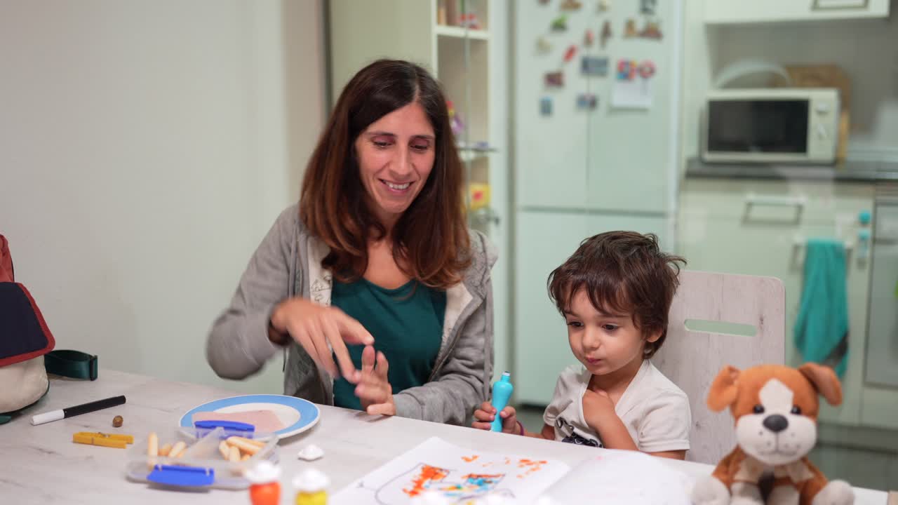 Mother and child drawing at the table