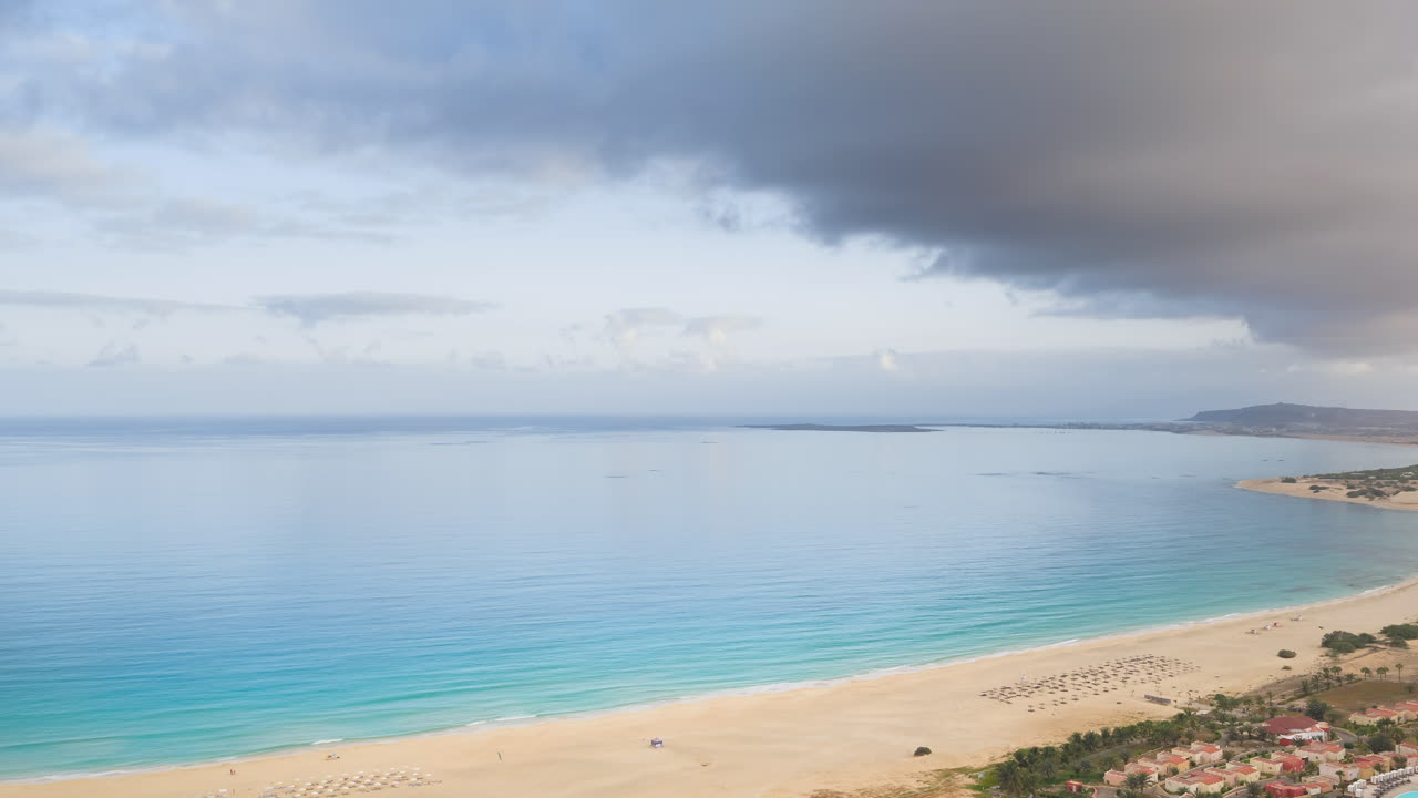 Drone view of a sandy beach,luxury resort,parasol and Atlantic Ocean,turquoise ocean at sunny day,Boa Vista,Cape Verde