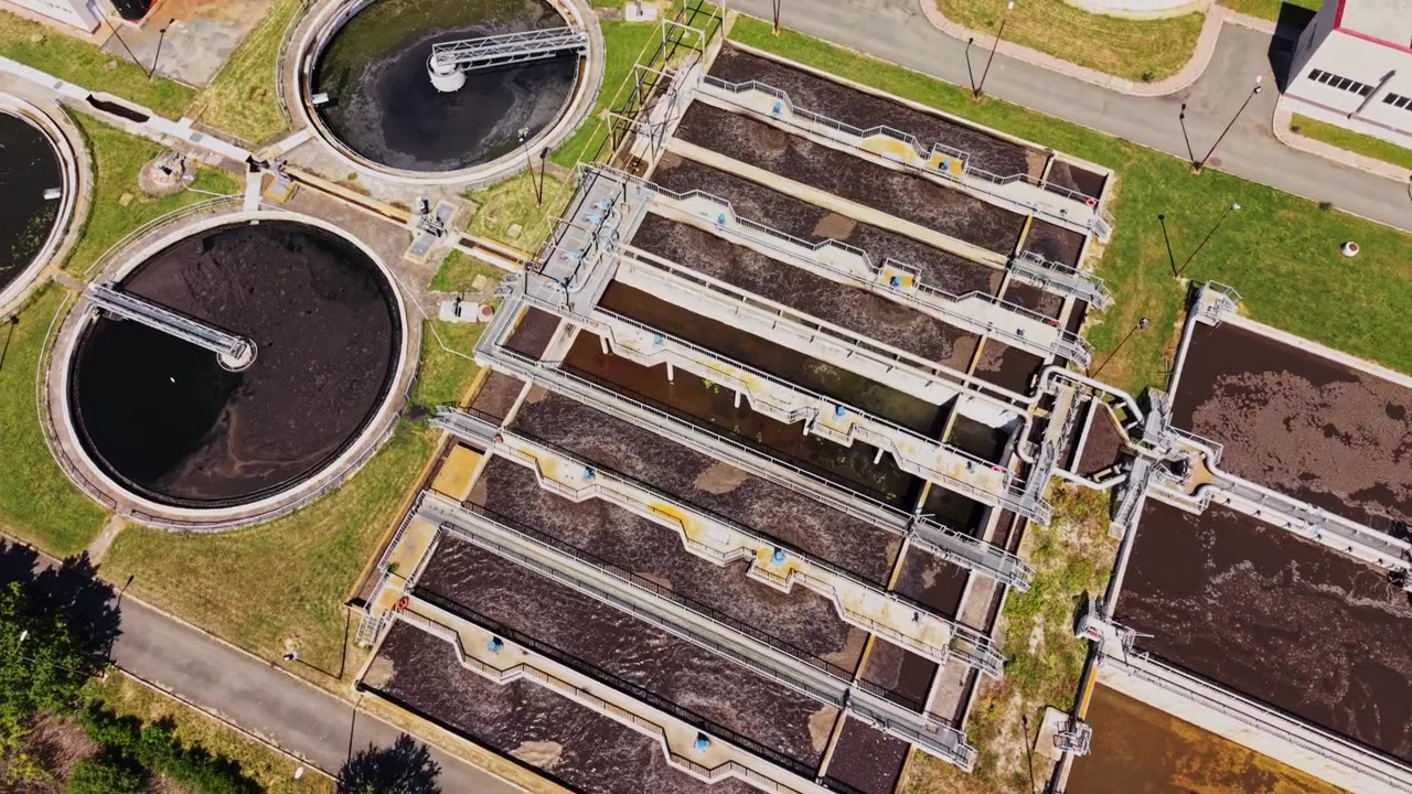 Water treatment facility showing tanks and processing areas in a city
