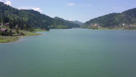 Aerial-Slow-panning-shot-of-Valley-with-Lake-and-trees