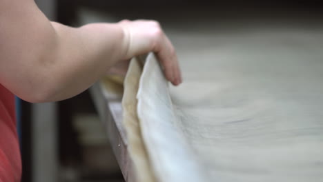 a female worker is preparing a rubber protection blanket for products to be heated in the furnace