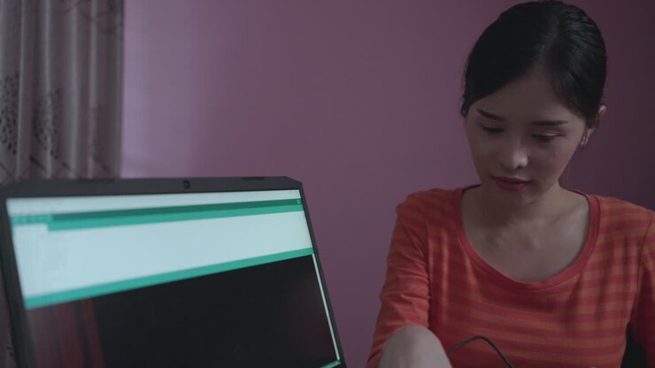Technician Asian woman assembles electronic circuits with a microcontroller board open-source hardware and software