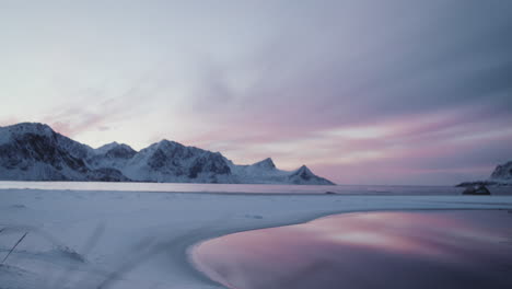 spectacular sunset over snow covered mountains at lofoten, norway