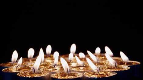 Background-of-tea-cup-glitter-Candles-Lights-shines-yellow-gold-bright-for-celebration,-religion,-anniversary-Festival