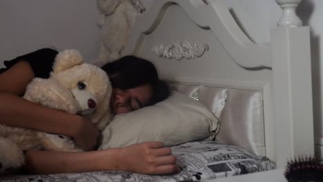 girl sleeping with her teddy bear