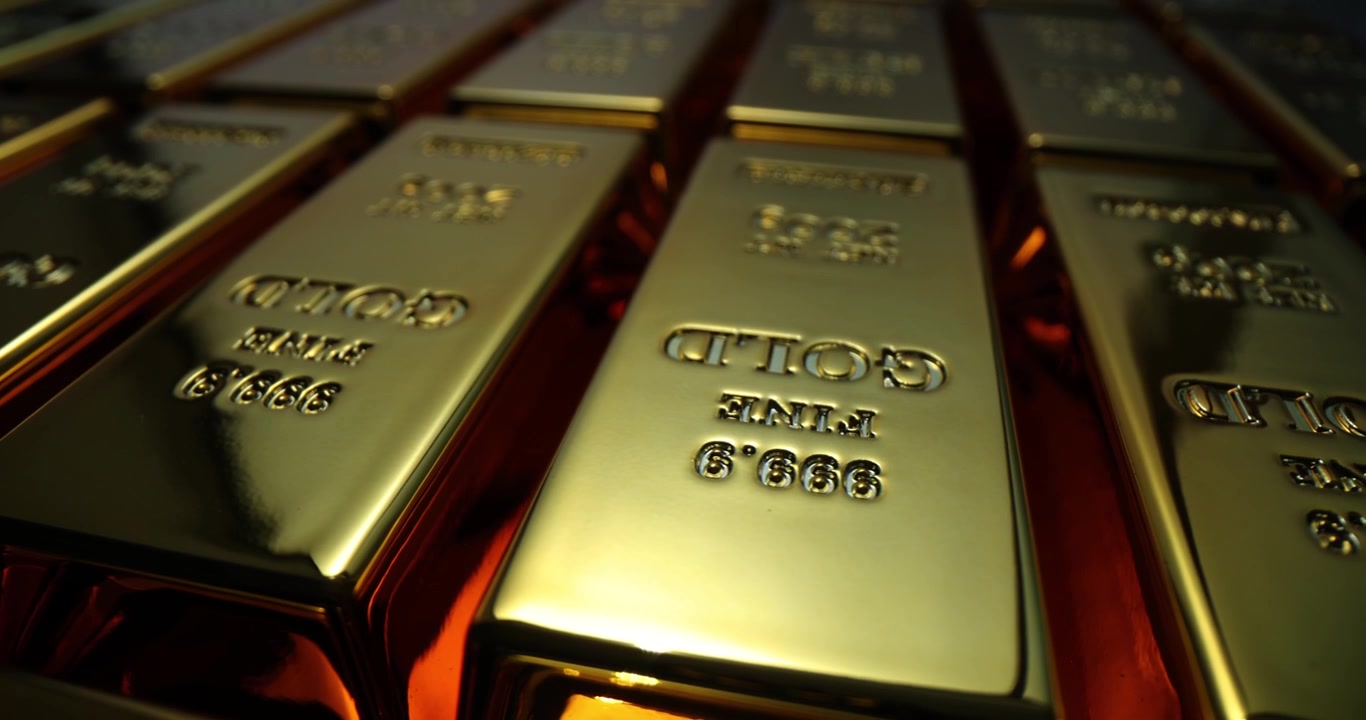 Lingotti d'oro che brillano delicatamente, contrassegnati, in una cassaforte protetta.