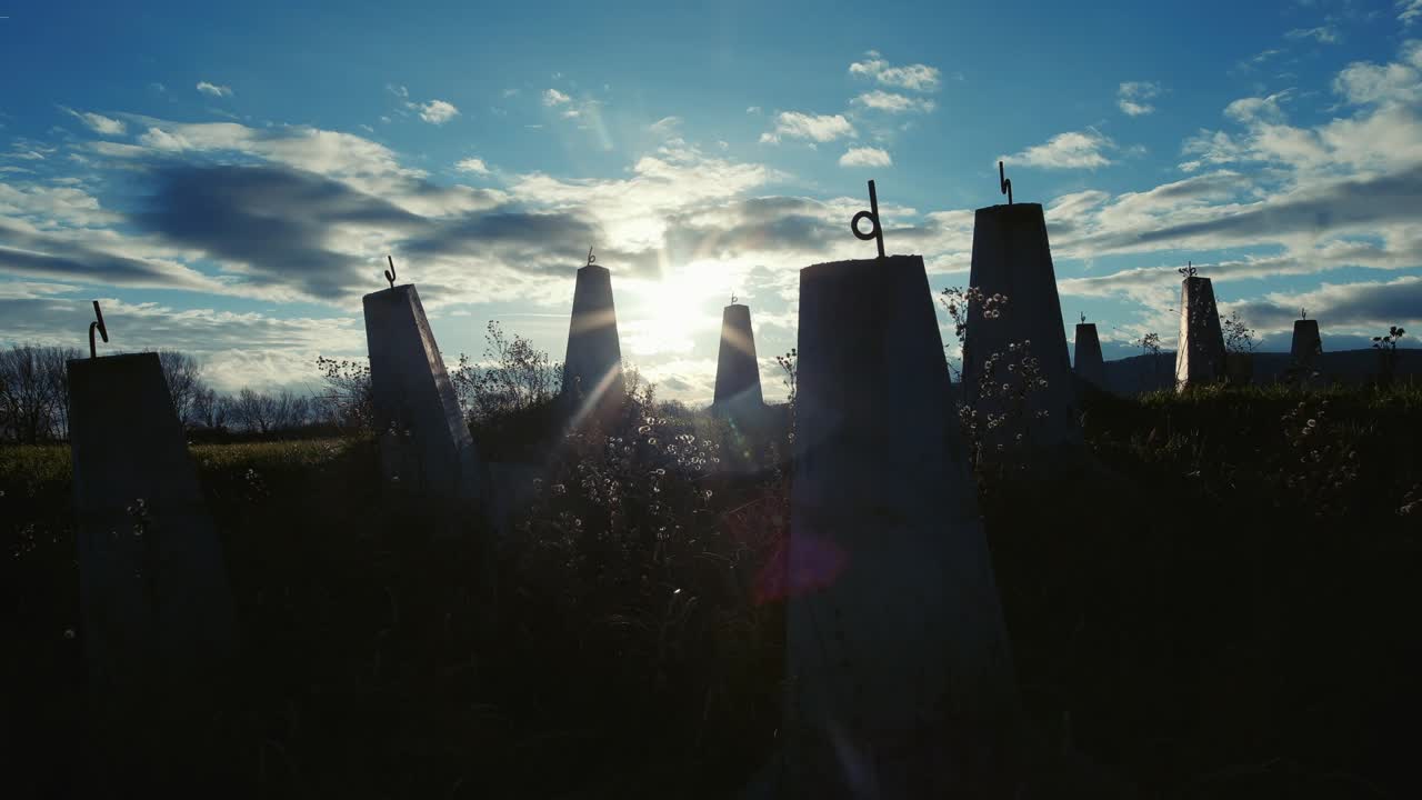 Old tank traps near world war two site with sun behind.