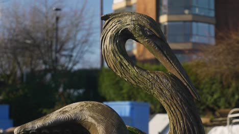 close-up of a weathered wooden bird sculpture