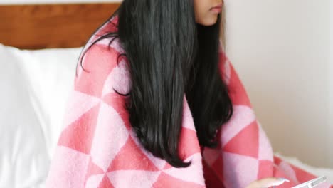 woman using mobile phone in bedroom