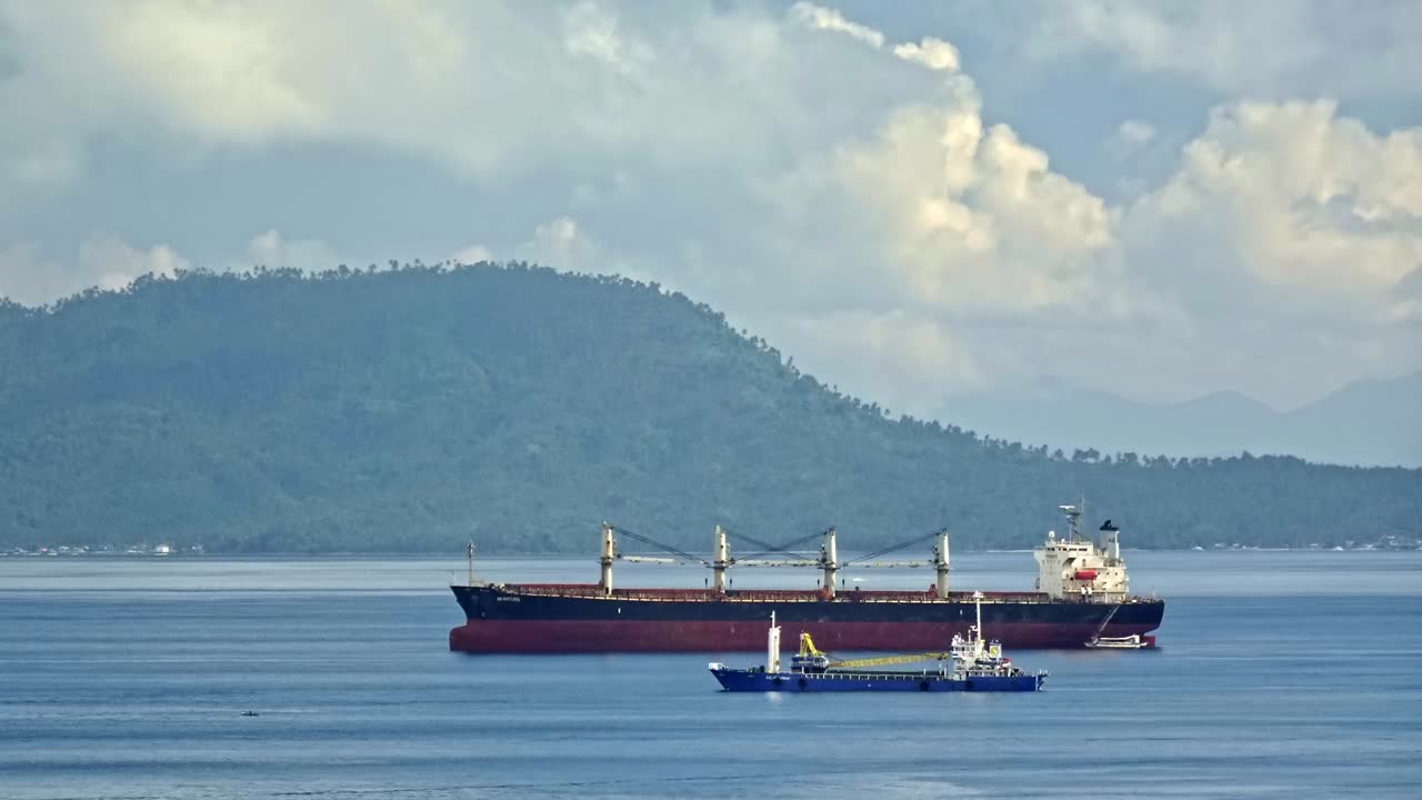 Premium stock video - Cargo ship approaching surigao port through the ...