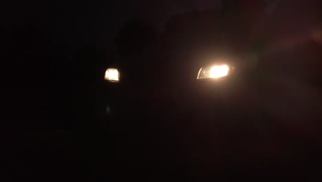 close up car head lamps shining bright at night