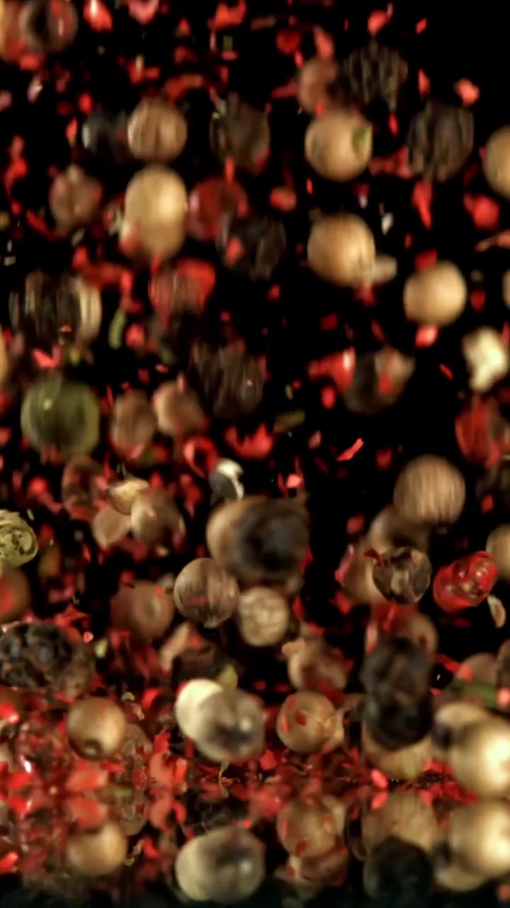 Assorted Peppercorns and Red Spices Falling in Slow Motion