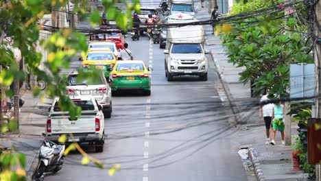 vehicles and pedestrians navigating a city street