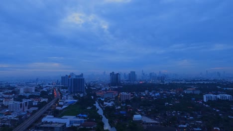 timelapsed rooftop view of downtown bangkok at blue hour