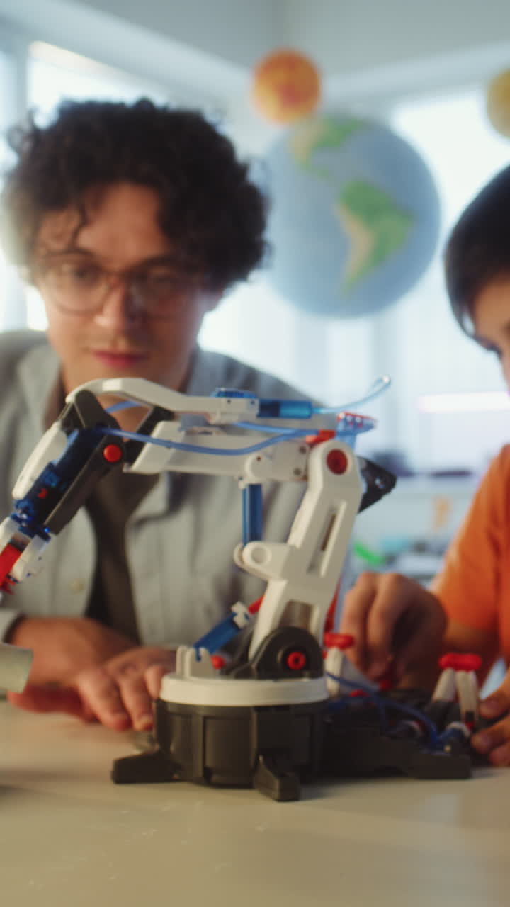 Students working with a robot arm