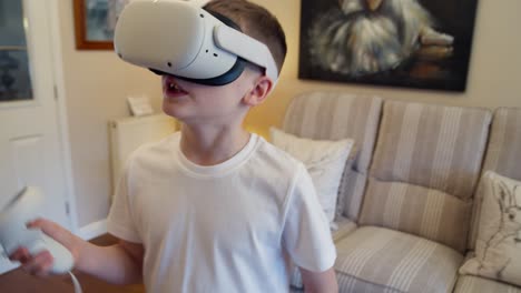 Child-plays-with-virtual-reality-goggles-and-wireless-remote-control-in-hand