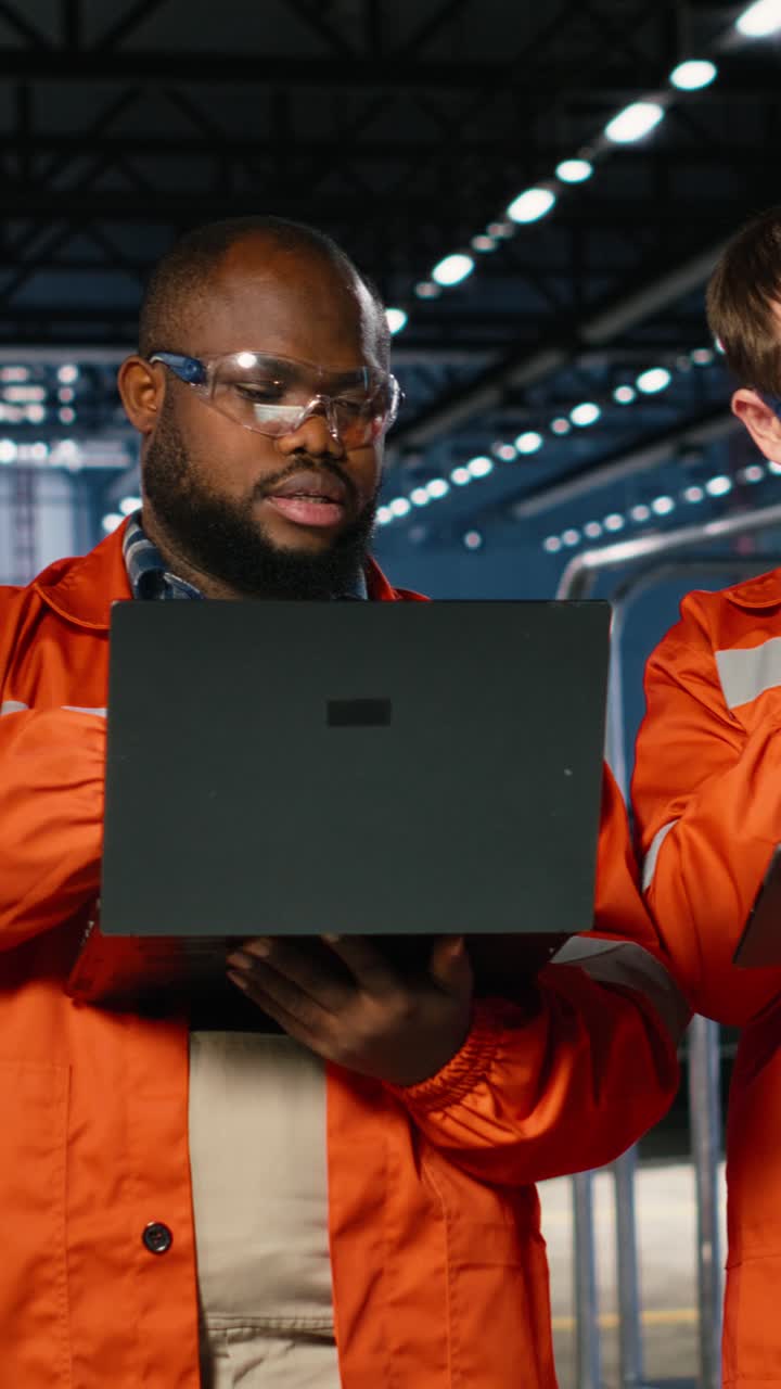 Vertical Video Diverse workers using devices to manage steel production tasks