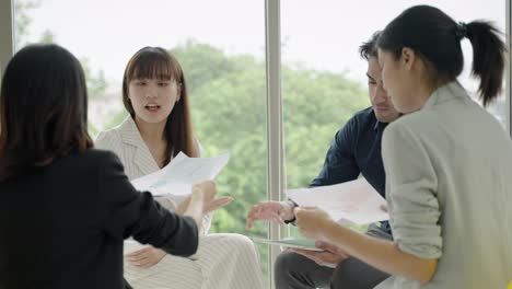 asian group therapy sitting around listening to the problems of friends within the group,psychiatric nurses,psychotherapy,mental health