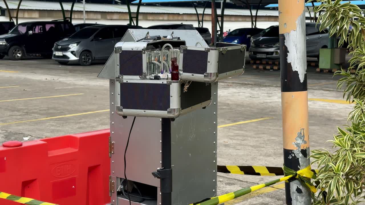 Outdoor air quality monitoring station installed in a parking lot, showing exposed gas analysis instruments and tubing used for environmental pollution measurement. Impinger and HVAS machine