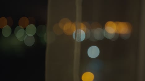 blurred background from a night window covered with tulle