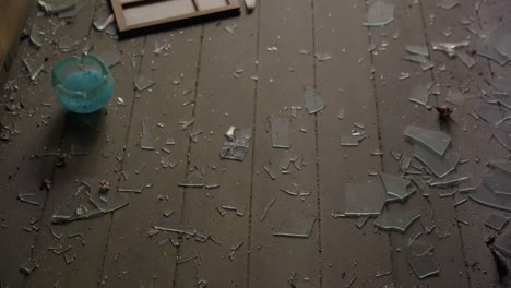 broken glass and window pane on floor of abandoned ruined mansion