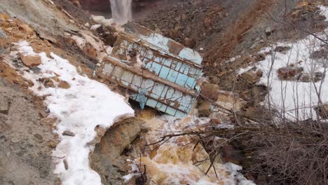 landslide with damaged structure and waterfall