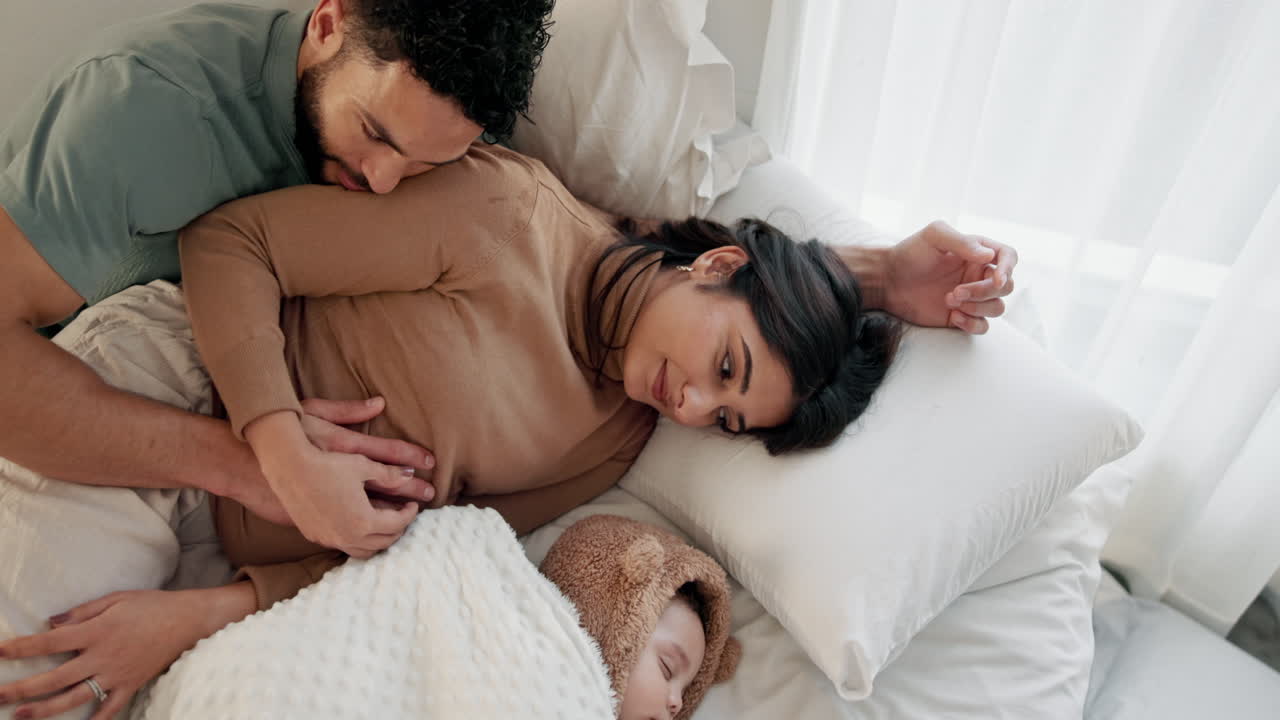 Happy family in bed with their newborn baby