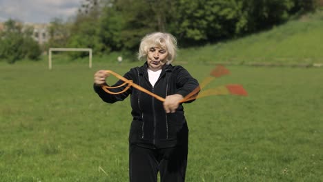 senior woman jumping rope in a park