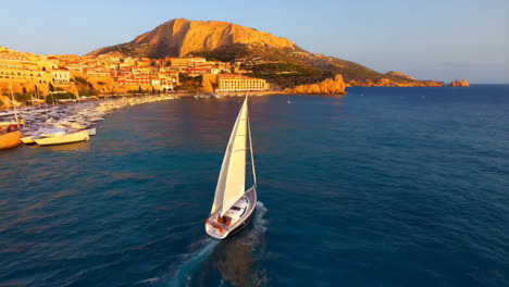 sailing yacht in a beautiful coastal harbor at sunset