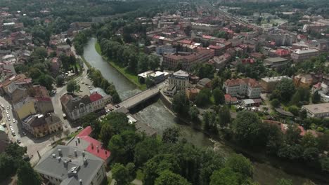 a breathtaking aerial view of a grand historic city in central europe, featuring a majestic river and a prominent large bridge