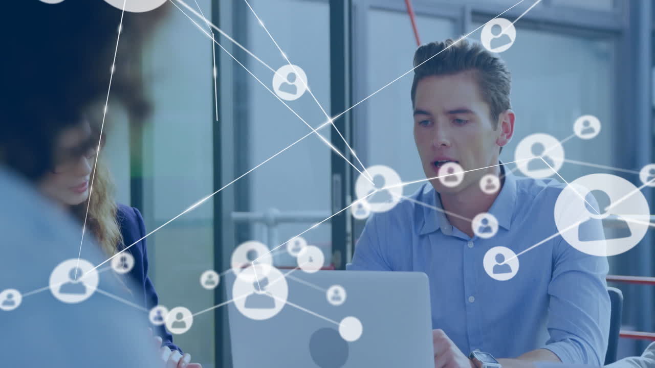Business professionals working on laptops with network connections animation overlay