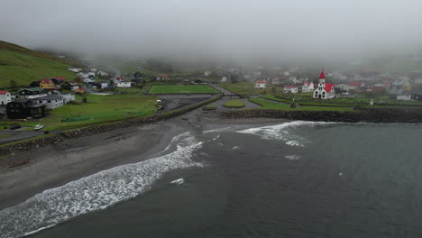 Sandavagur-village,-Vagar-Island:-circling-aerial-view-of-the-village-and-from-the-coast