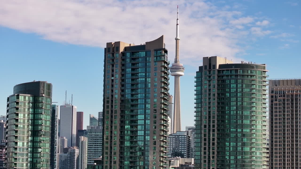Drone flying through the buildings of downtown Toronto with CN Tower in view
